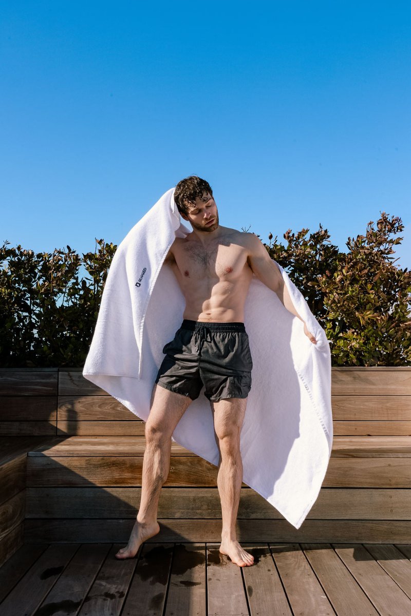 The Glacier Towel-big bath towel-Turkish towel-man holding up towel outside